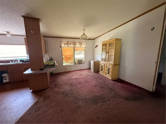 a living room with furniture and large windows