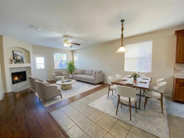 a living room with fireplace furniture and a wooden floor