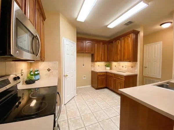 a kitchen with a sink a stove and cabinets