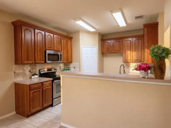 a kitchen with a sink stove and microwave