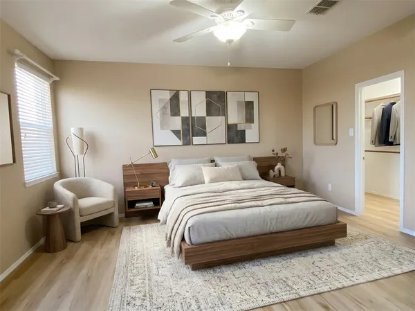 a bedroom with a bed and wooden floor