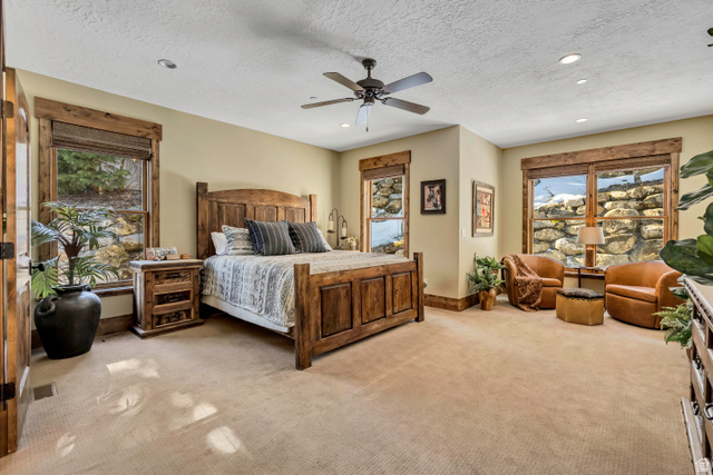 9049 Timphaven Road Sundance, UT 84604 - Photo 17 of 63 Bedroom with recessed lighting, light colored carpet, a textured ceiling, and ceiling fan