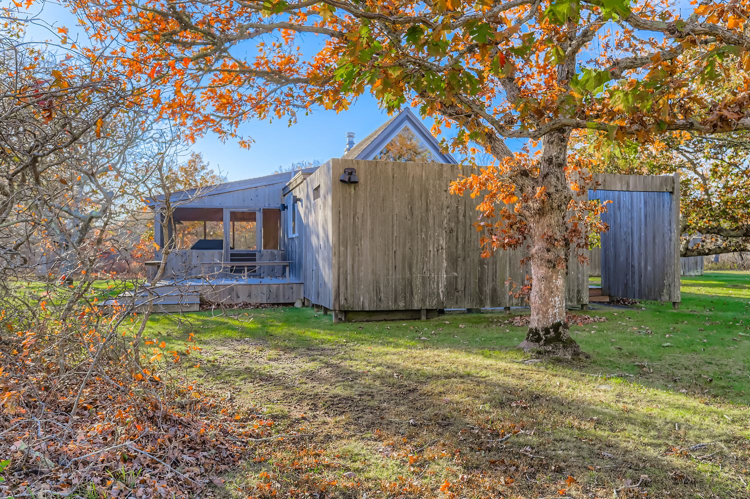 7 Black Point Road Chilmark, MA 02535 - Photo 26 of 48 a backyard of a house with barbeque oven fire pit and brick wall