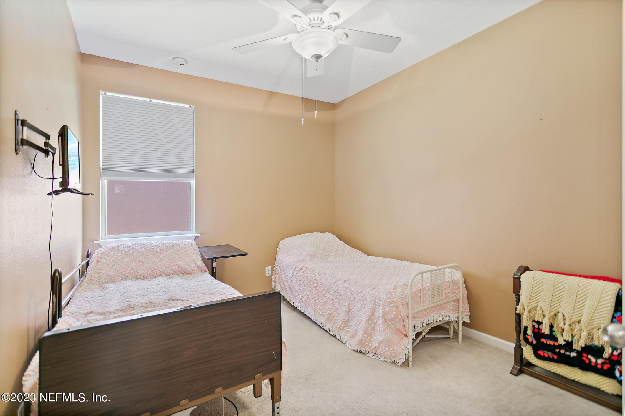 235 Pine Arbor Circle St. Augustine, FL 32084 - Photo 13 of 41 a bedroom with a bed and a chandelier