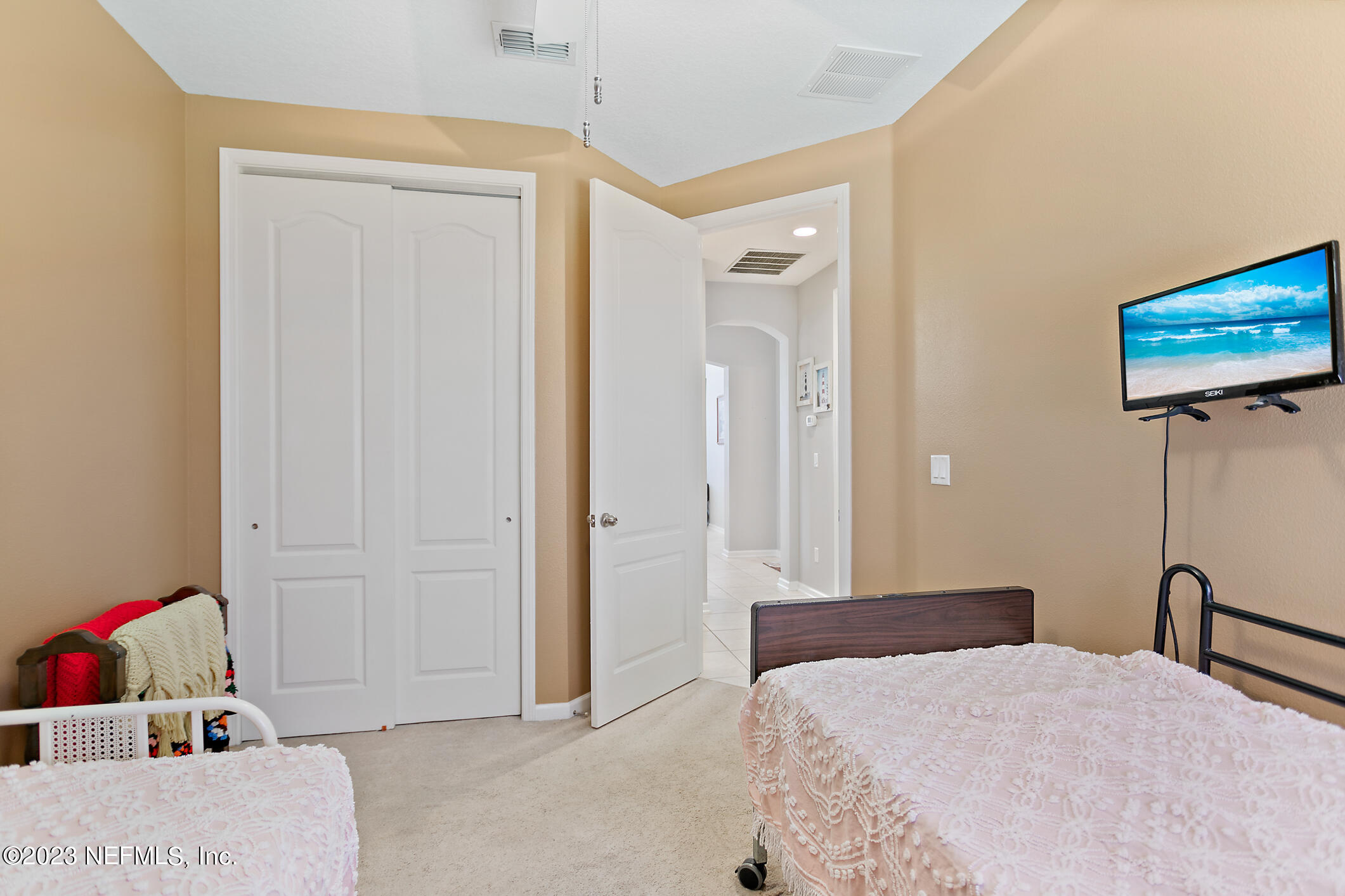 235 Pine Arbor Circle St. Augustine, FL 32084 - Photo 14 of 41 a bedroom with a bed and a flat tv screen on dresser