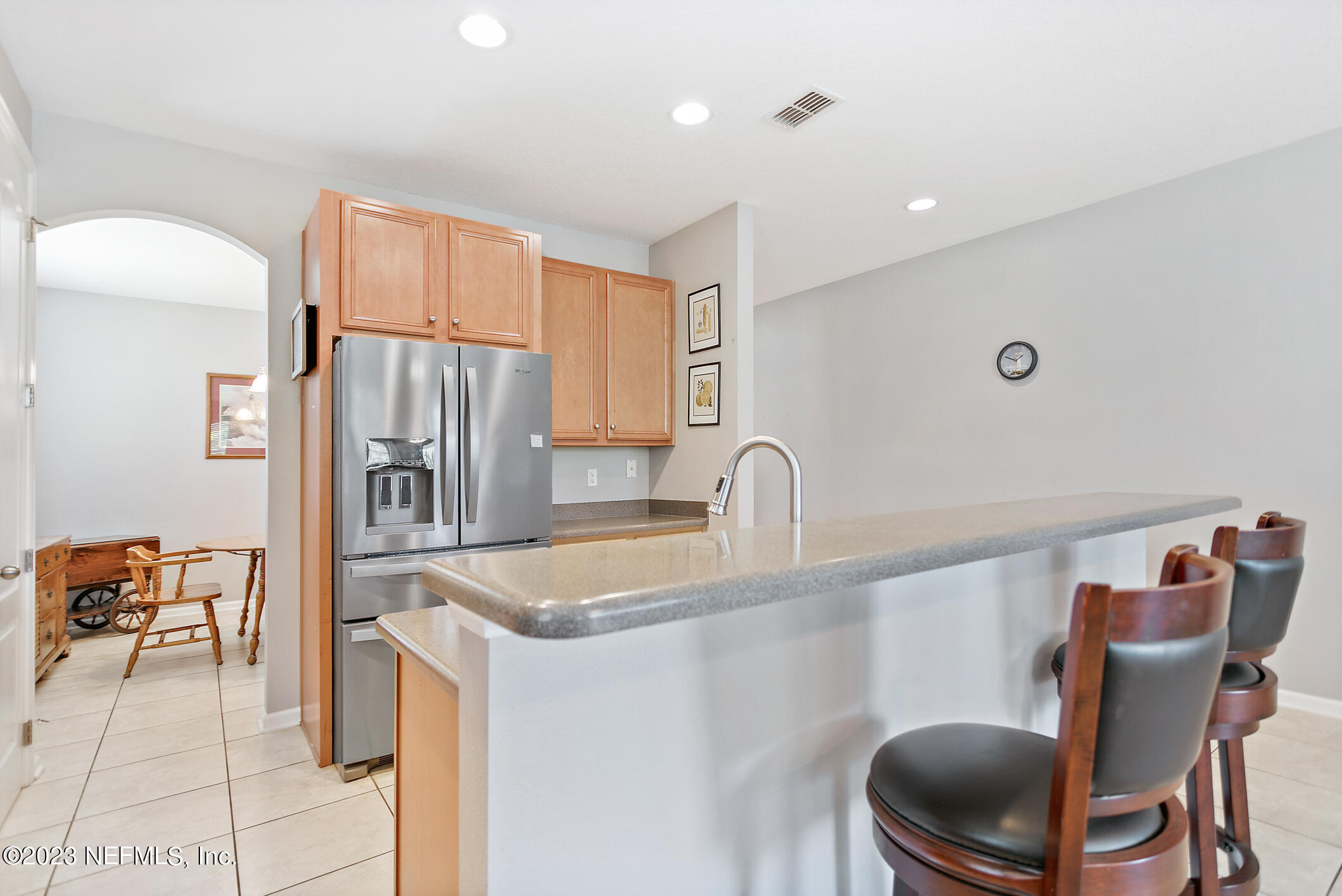 235 Pine Arbor Circle St. Augustine, FL 32084 - Photo 18 of 41 a kitchen with stainless steel appliances granite countertop a refrigerator a stove and a sink with wooden floor