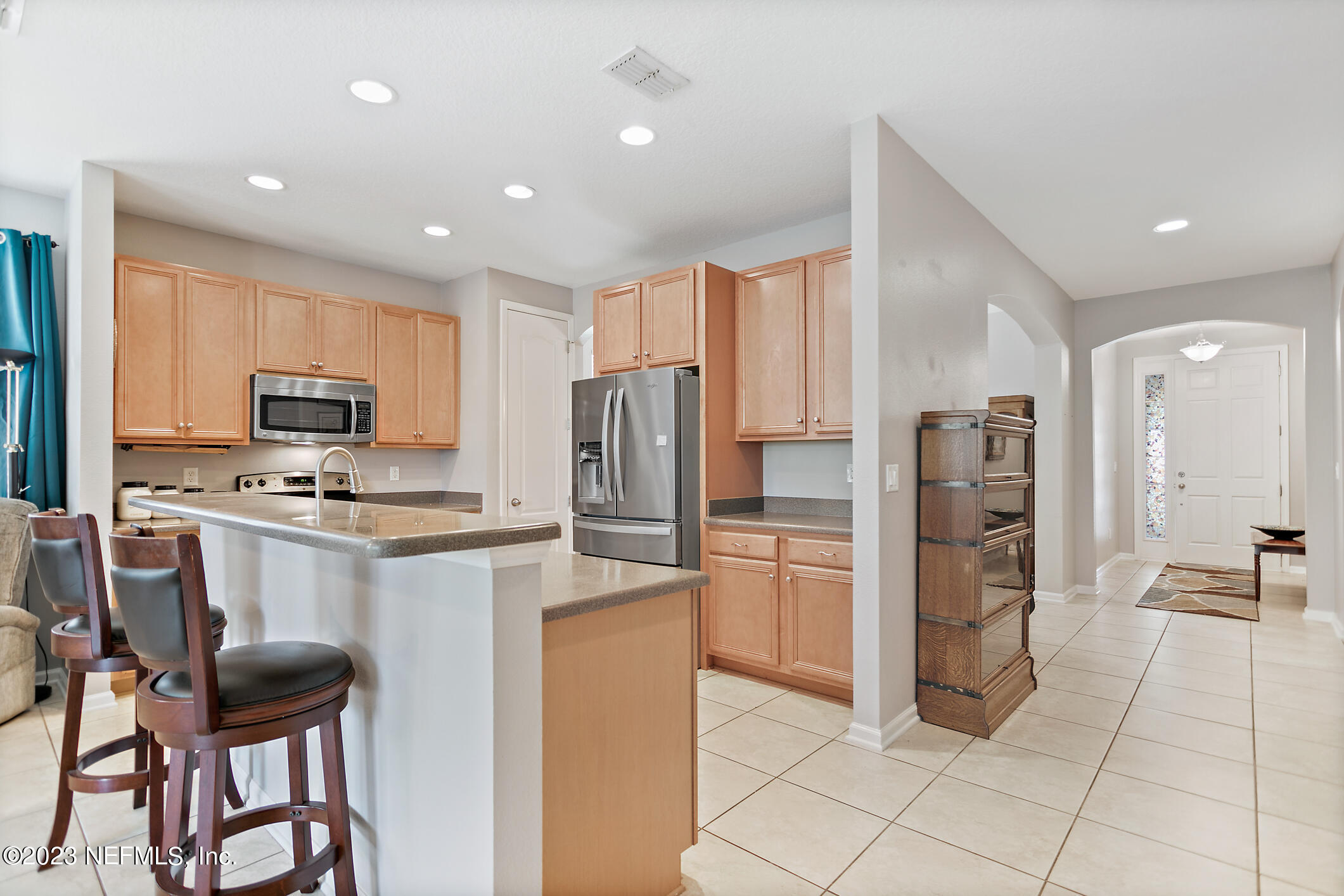 235 Pine Arbor Circle St. Augustine, FL 32084 - Photo 19 of 41 a kitchen with stainless steel appliances a refrigerator stove microwave and cabinets