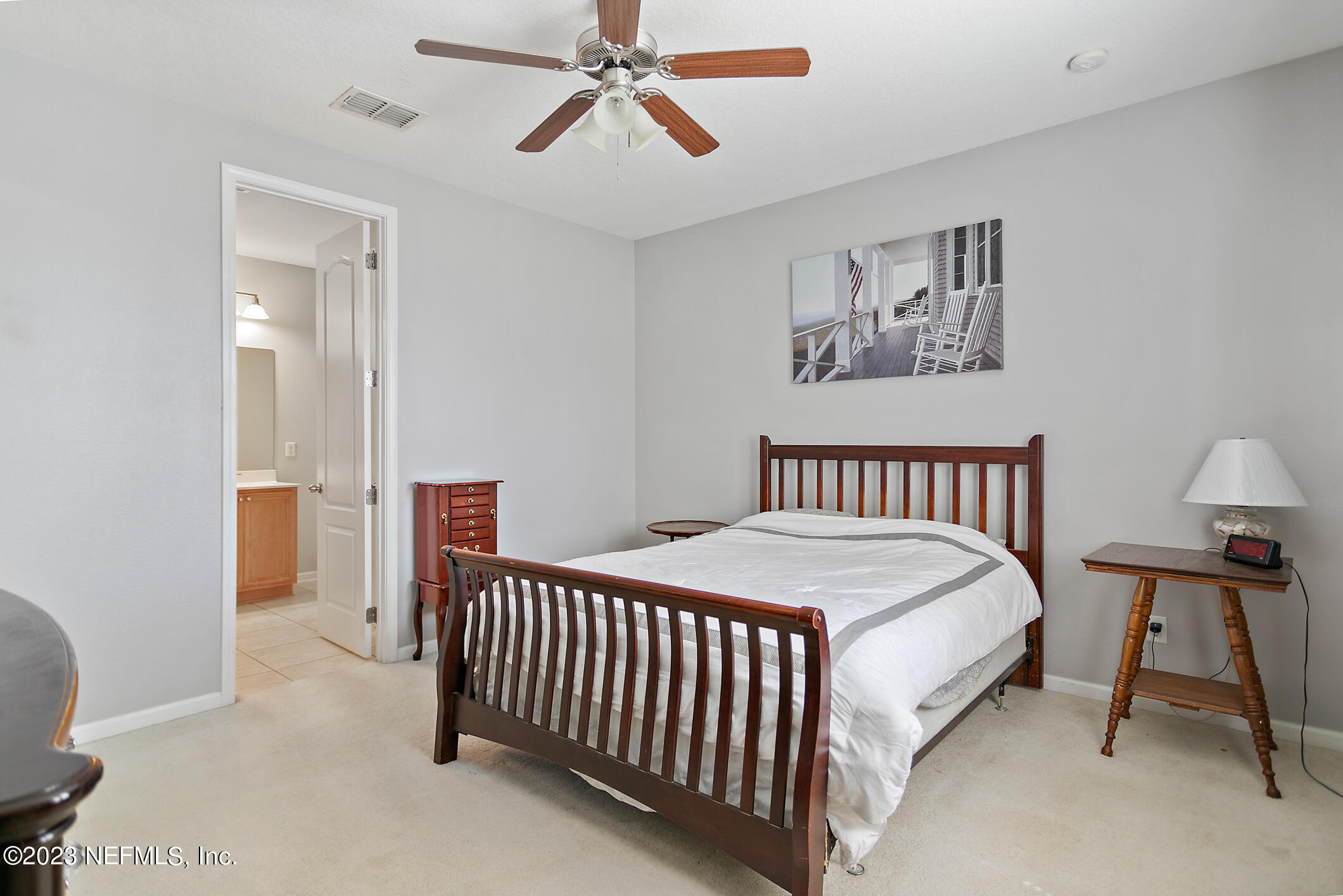 235 Pine Arbor Circle St. Augustine, FL 32084 - Photo 26 of 41 a bedroom with a bed and a lamp on table