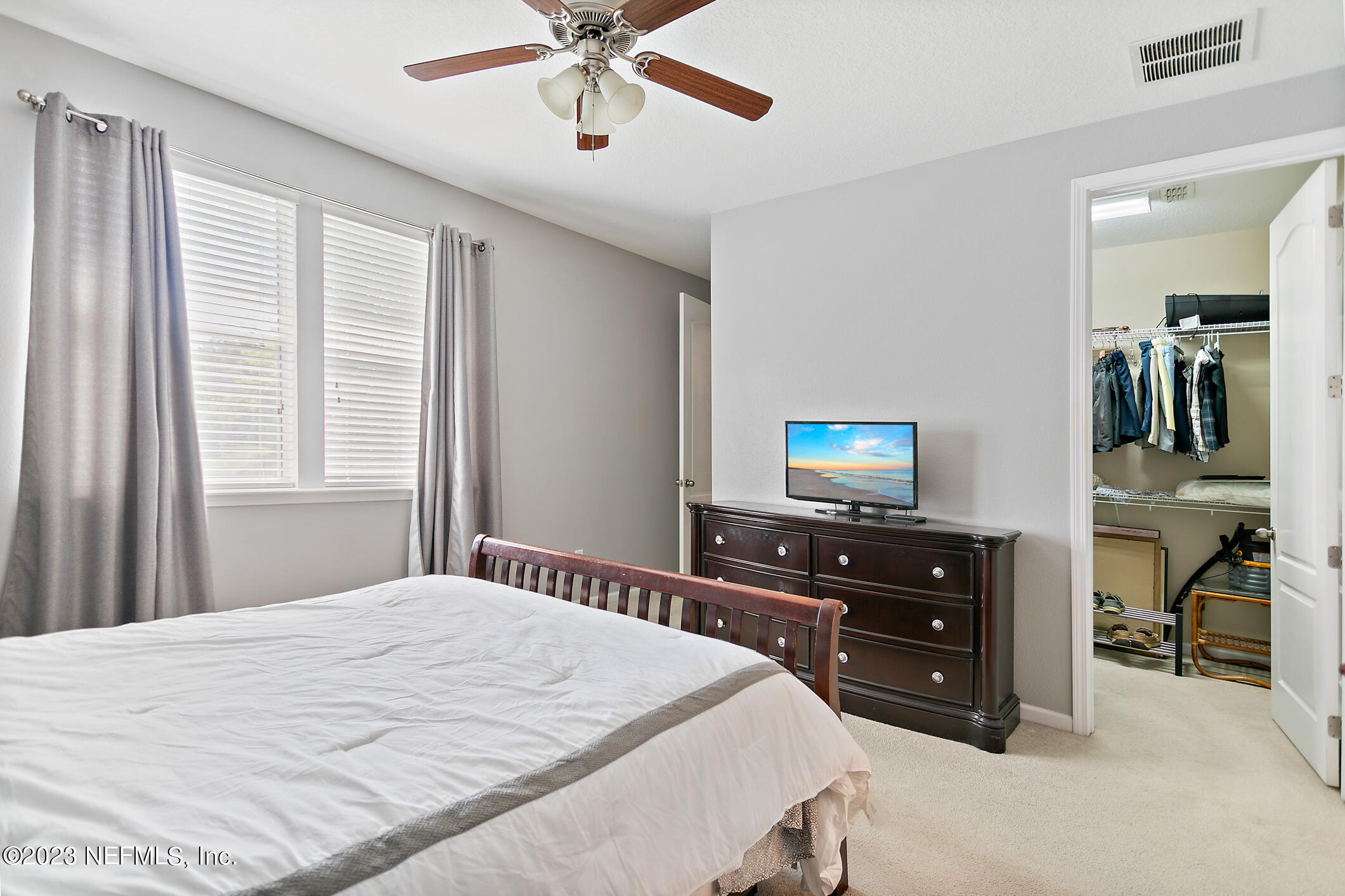 235 Pine Arbor Circle St. Augustine, FL 32084 - Photo 27 of 41 a bedroom with a bed and a flat tv screen on dresser