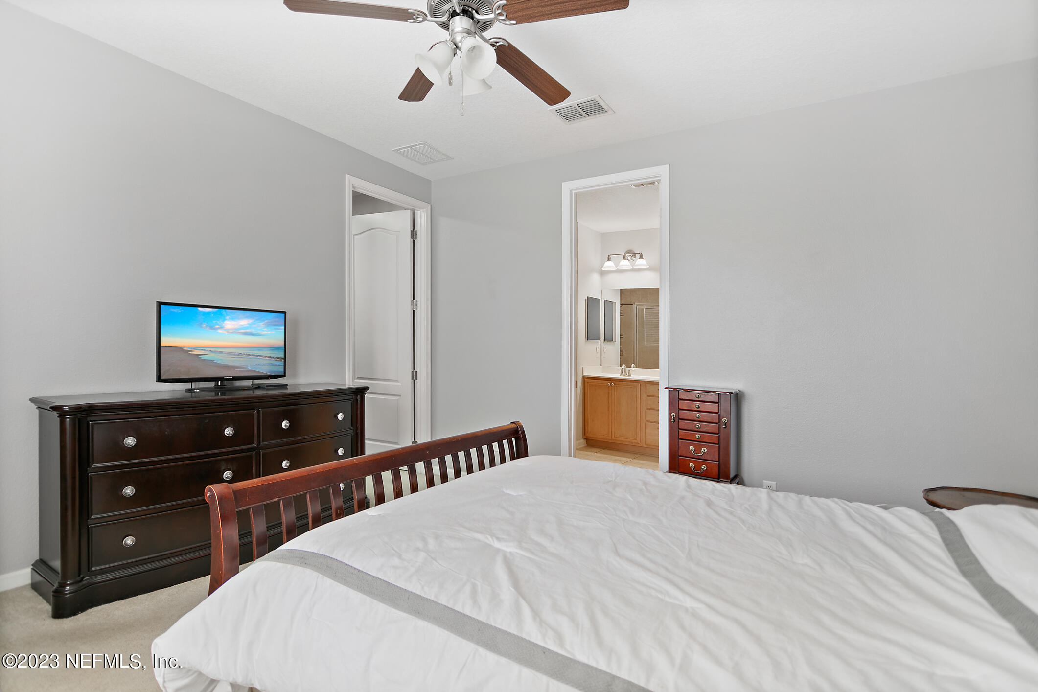 235 Pine Arbor Circle St. Augustine, FL 32084 - Photo 29 of 41 a bedroom with a bed and a flat tv screen on dresser