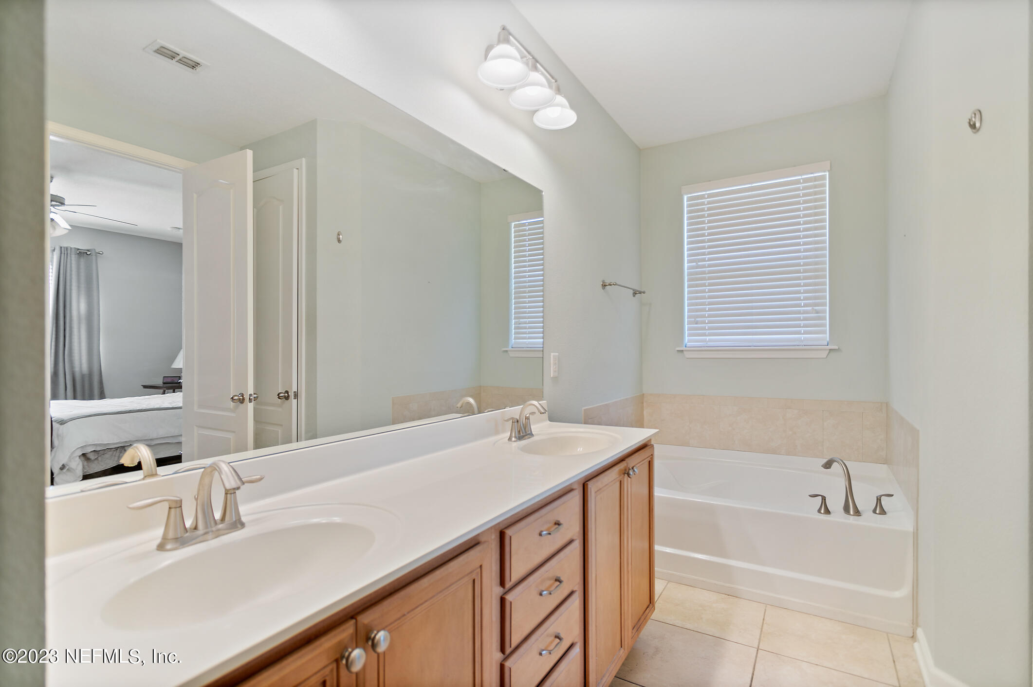 235 Pine Arbor Circle St. Augustine, FL 32084 - Photo 30 of 41 a bathroom with a sink double vanity granite tub and a mirror
