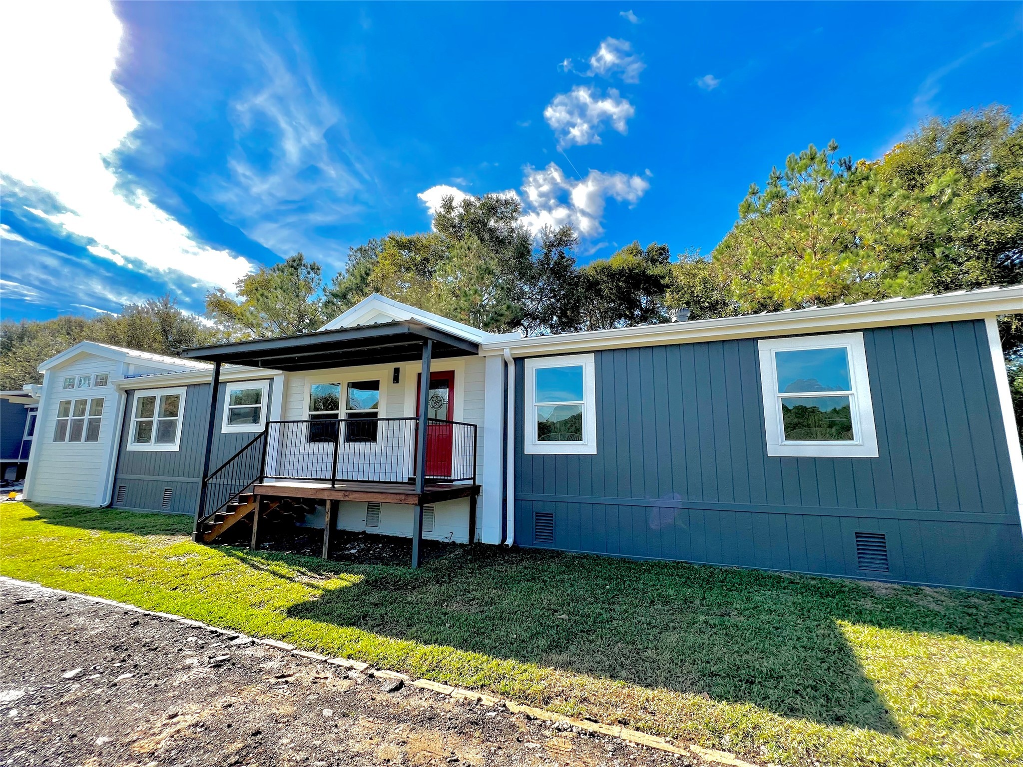 a view of a house with a backyard porch and sitting area