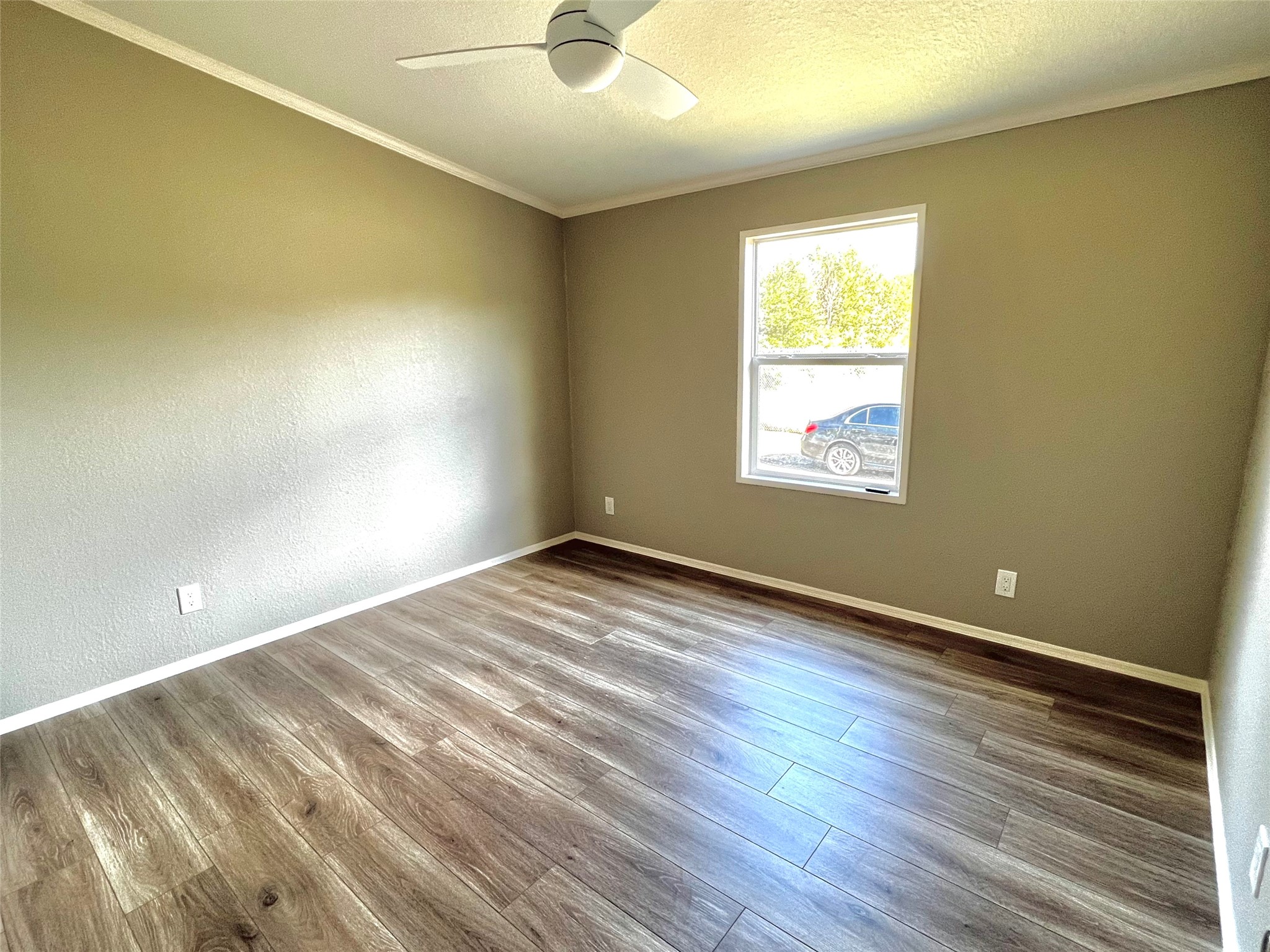 14505 Alice Road Tomball, TX 77377 - Photo 23 of 28 an empty room with wooden floor and windows
