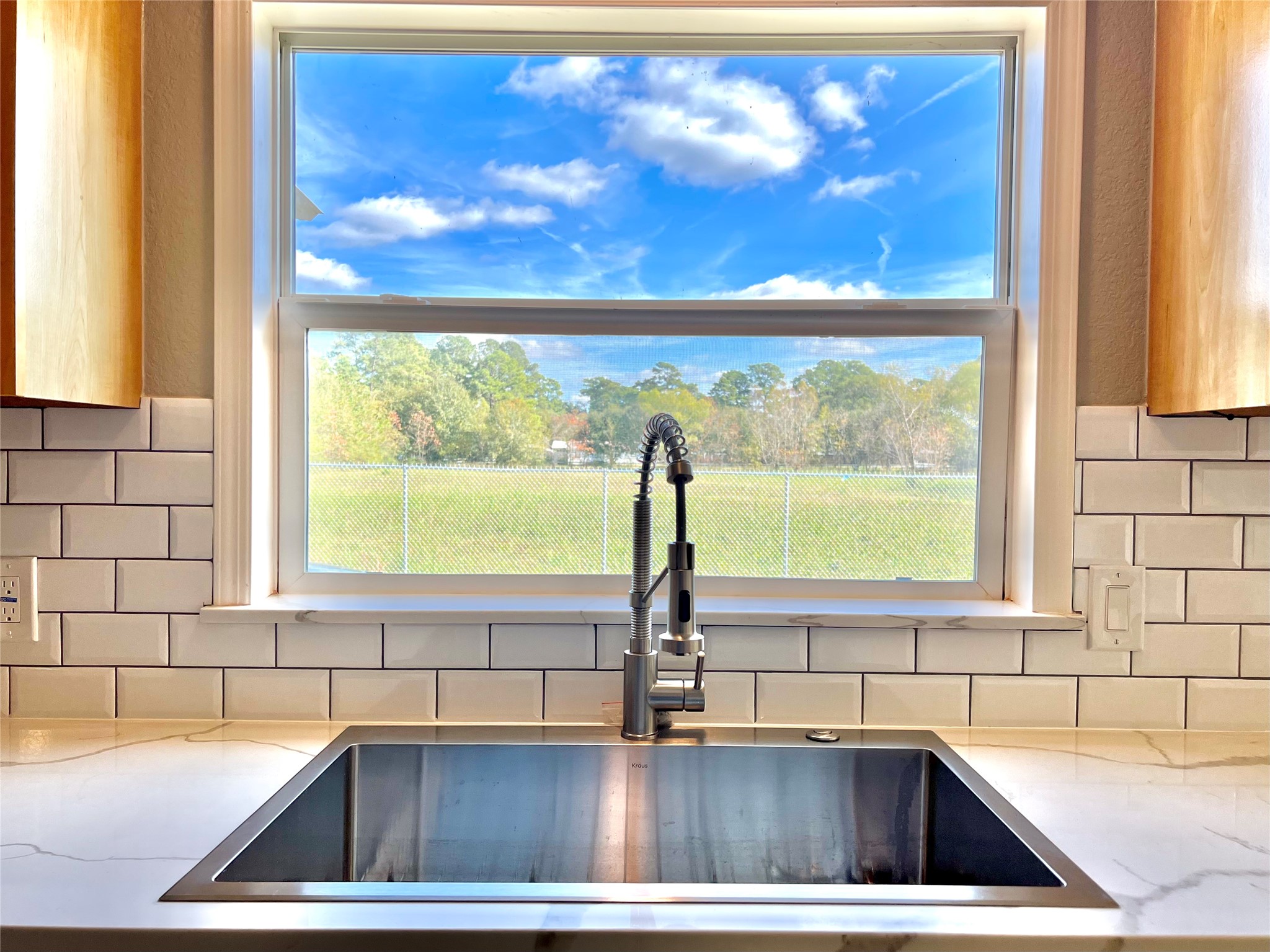 14505 Alice Road Tomball, TX 77377 - Photo 8 of 28 a view of kitchen sink window and cabinets