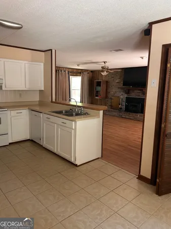a kitchen with stainless steel appliances a sink stove and cabinets
