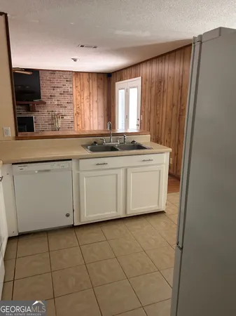 an empty room with wooden floor and cabinet