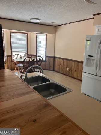 an empty room with wooden floor a fireplace and window
