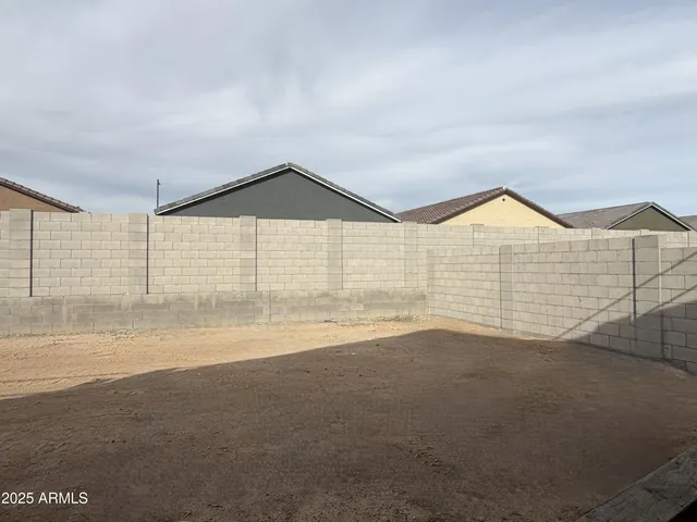 a view of an empty room with wooden floor and windows