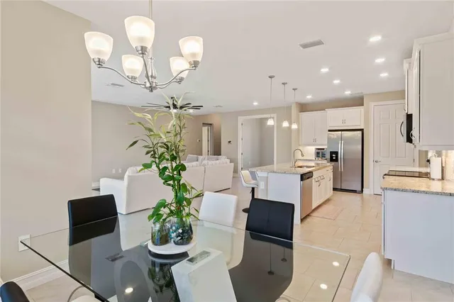 a bedroom with a bed and a chandelier fan