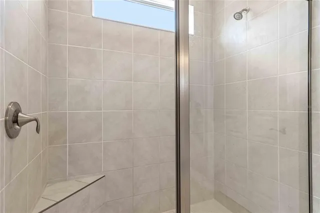 a view of empty room with wooden floor and floor to ceiling window