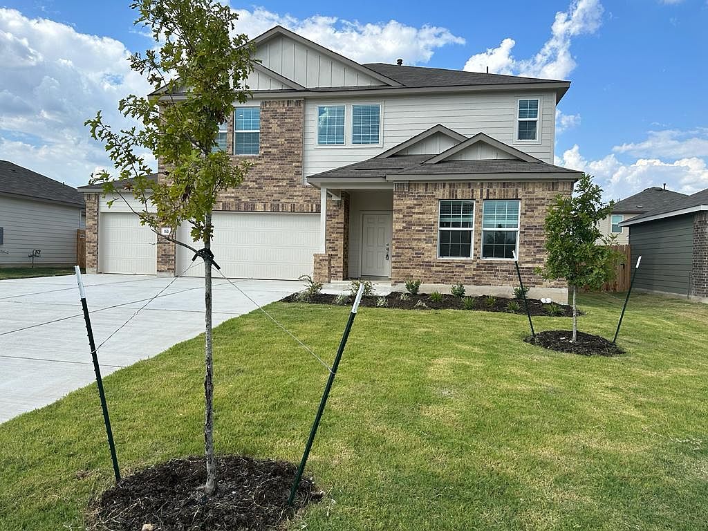 160 River Rise Road Kyle, TX 78640 - Photo 2 of 35 Two-story residence featuring a brick and siding facade, a two-car garage, and a covered entry