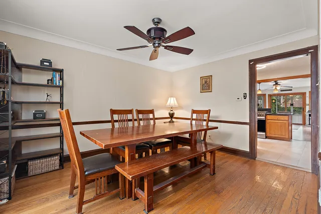 a dining room with furniture and wooden floor