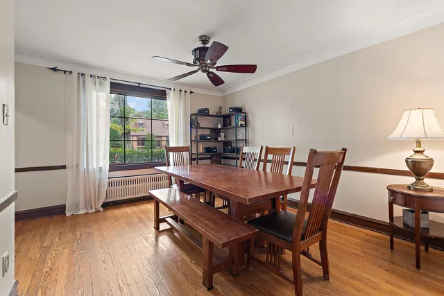 a dining room with furniture and wooden floor