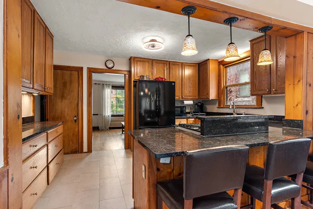 a kitchen with stainless steel appliances granite countertop a stove and refrigerator