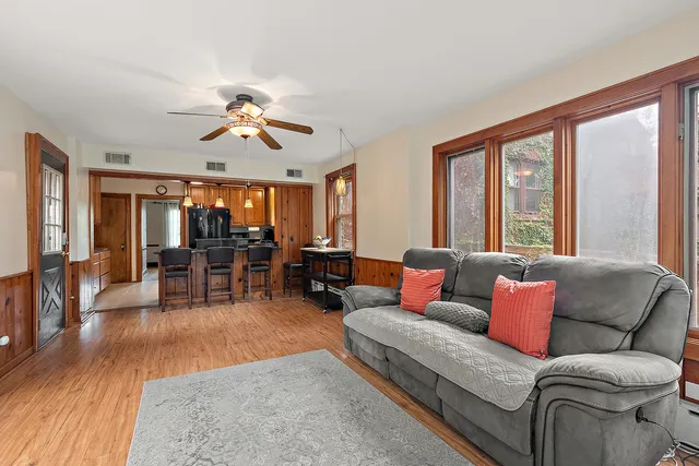 a living room with furniture and wooden floor