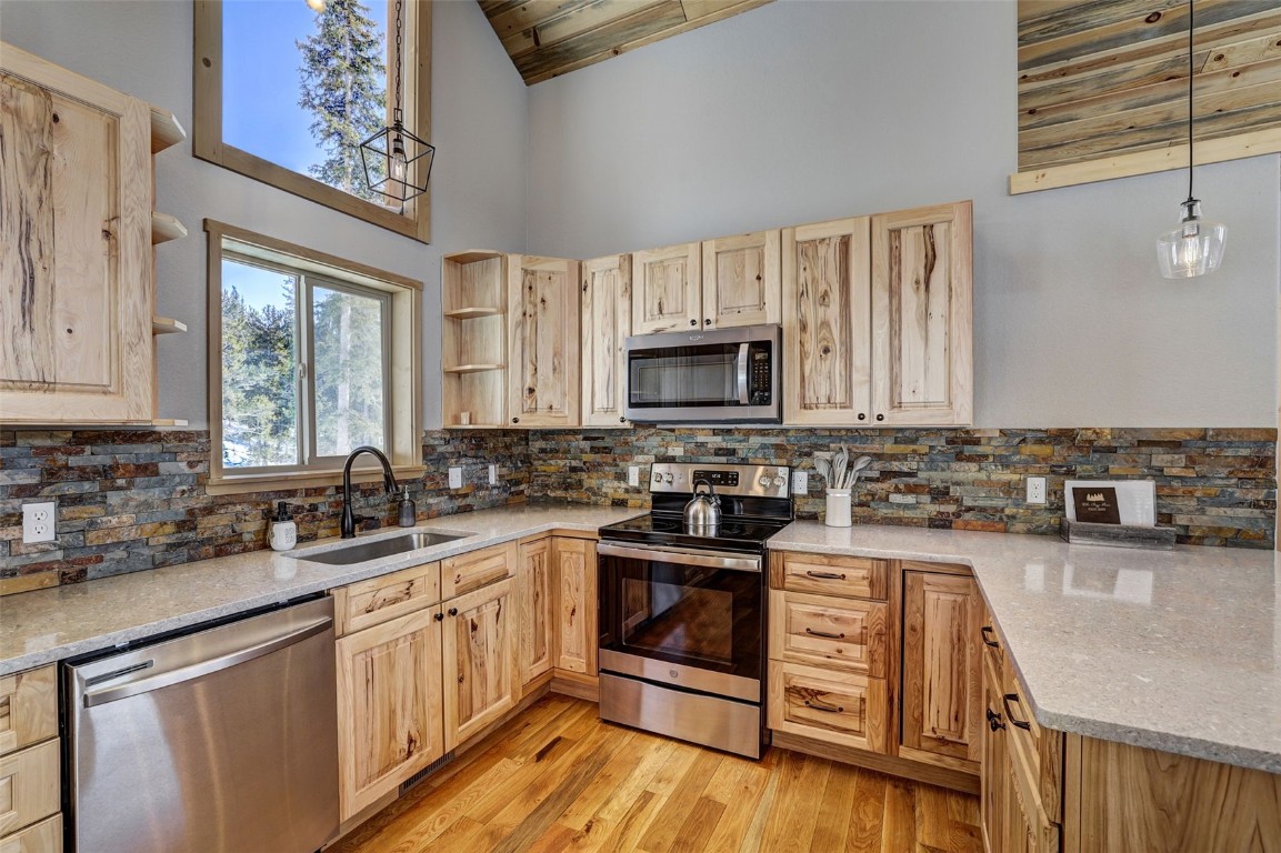 207 Pine Cone Way Fairplay, CO 80440 - Photo 12 of 45 a kitchen with a sink stove top oven and microwave