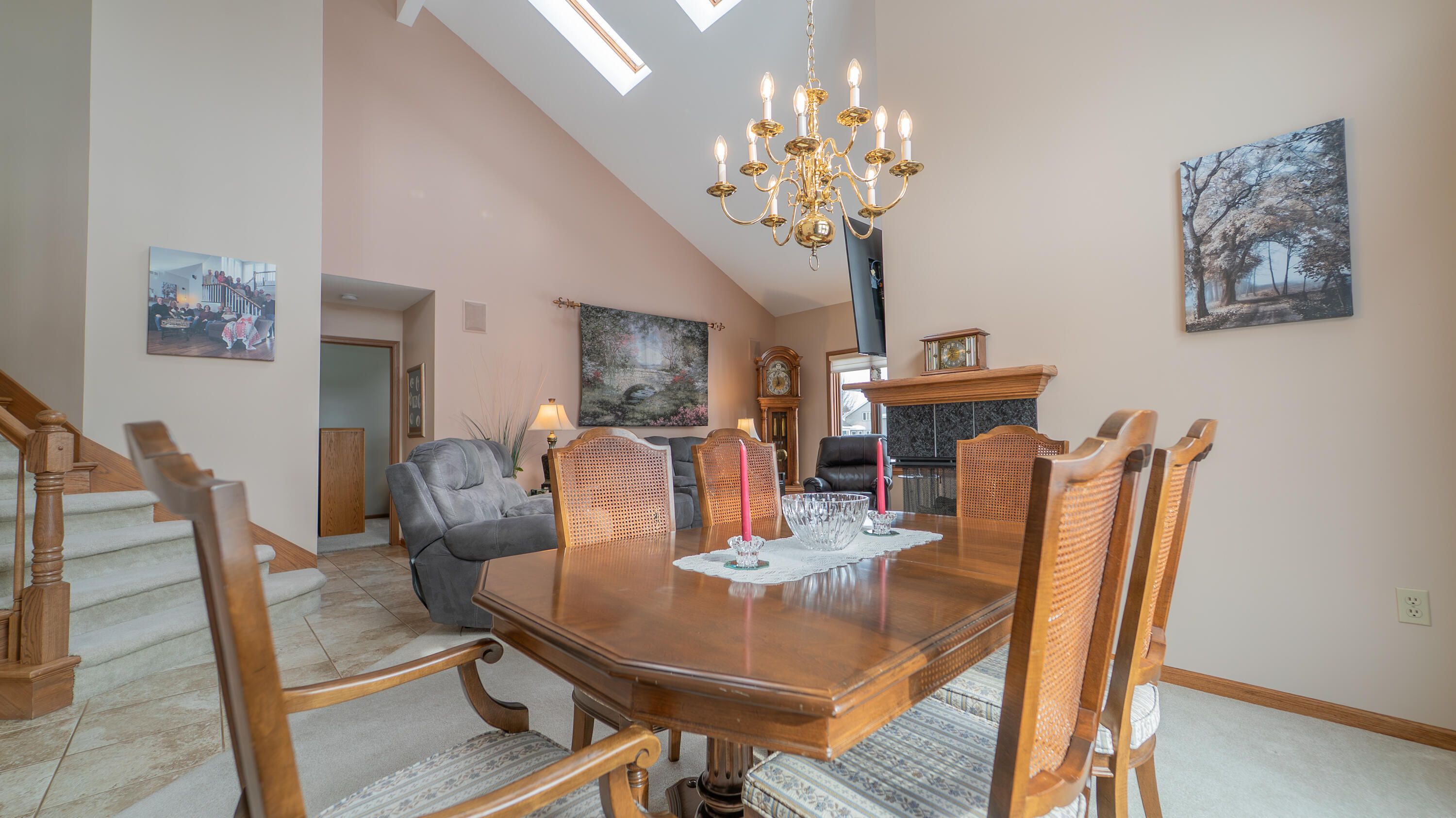 9427 Van Buren Street Crown Point, IN 46307 - Photo 10 of 46 a dining room with furniture a chandelier and wooden floor