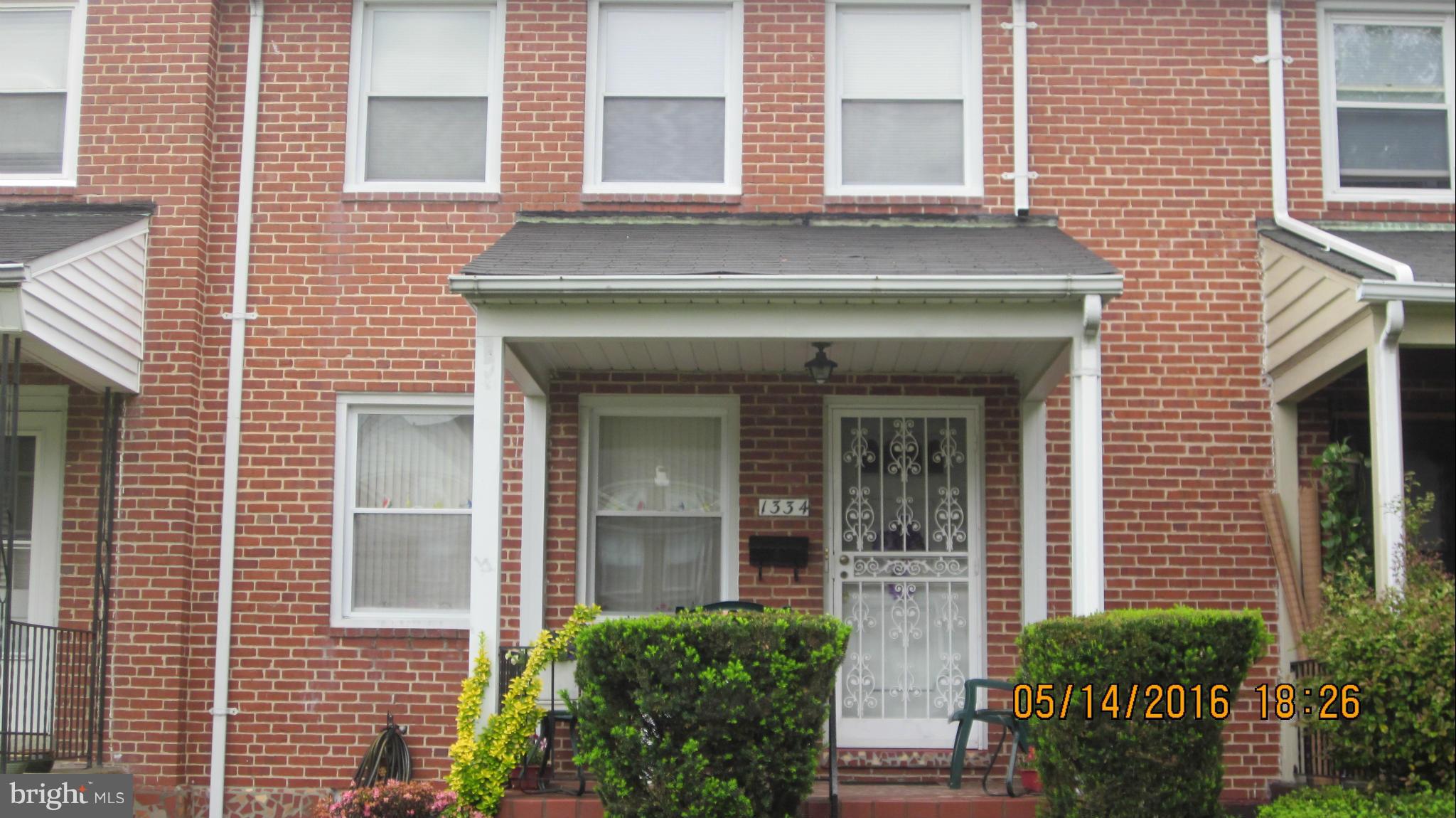 1334 Stonewood Road Baltimore, MD 21239 - Photo 2 of 18 a view of a brick house with many windows