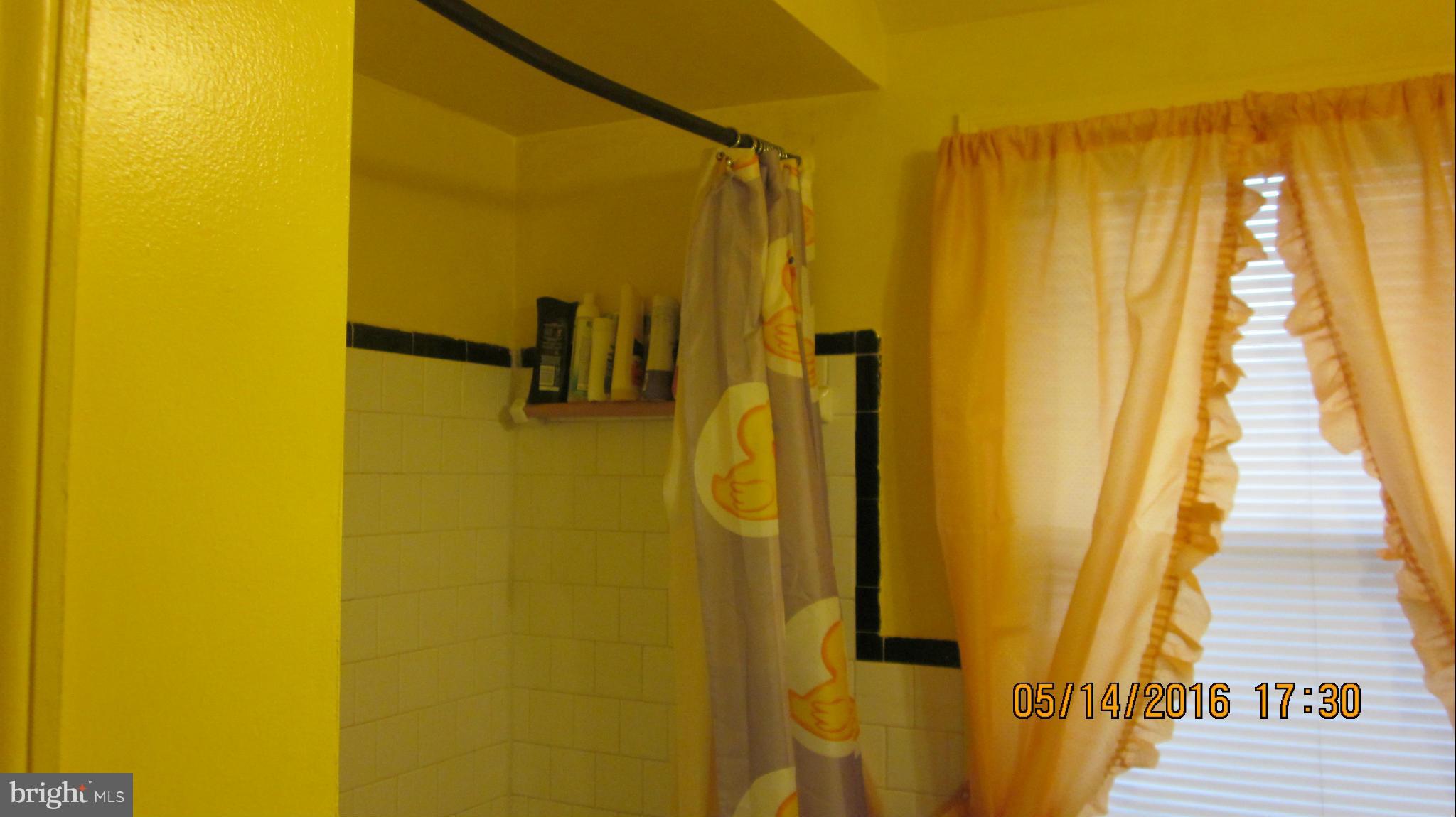 1334 Stonewood Road Baltimore, MD 21239 - Photo 13 of 18 a bathroom with a shower