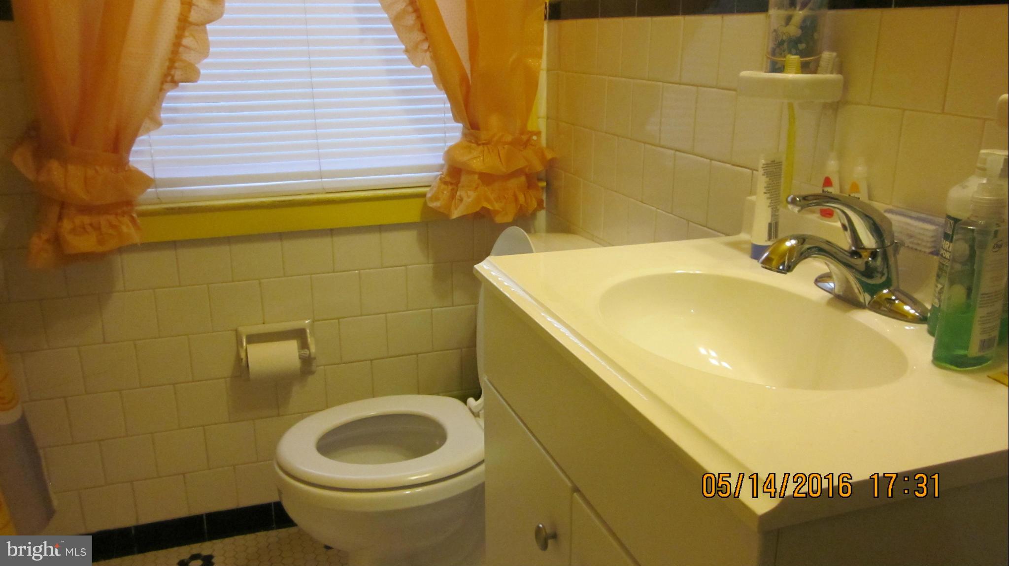 1334 Stonewood Road Baltimore, MD 21239 - Photo 14 of 18 a bathroom with a sink and a toilet
