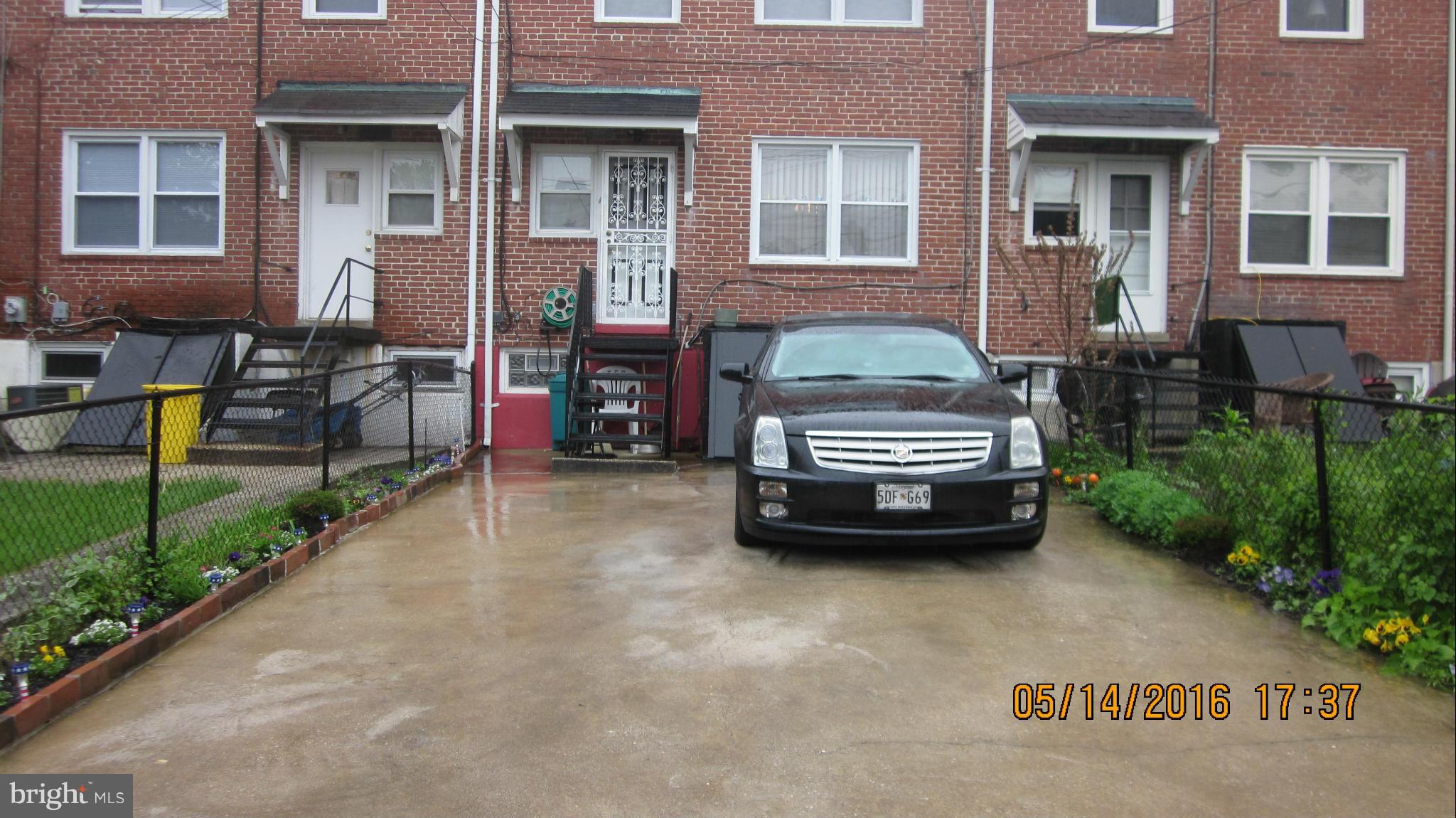 1334 Stonewood Road Baltimore, MD 21239 - Photo 18 of 18 a car parked in front of a brick house