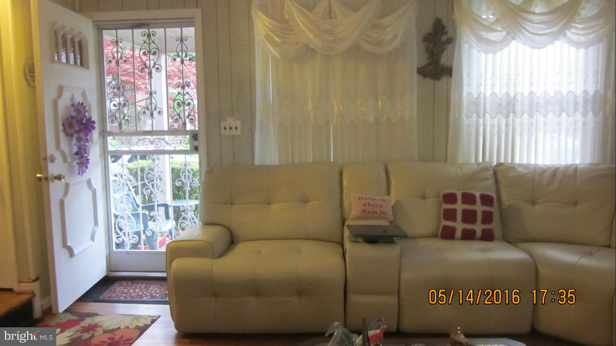 1334 Stonewood Road Baltimore, MD 21239 - Photo 6 of 18 a living room with furniture and a large window
