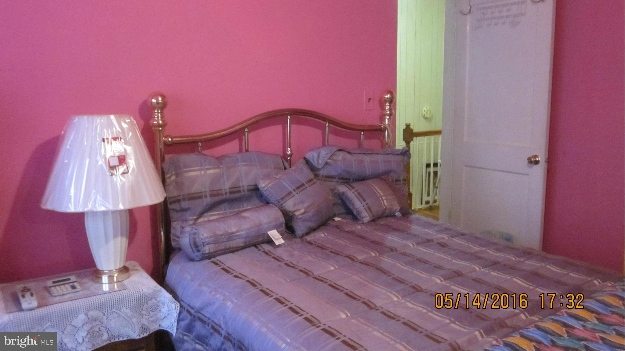 1334 Stonewood Road Baltimore, MD 21239 - Photo 10 of 18 a bedroom with a bed and a window