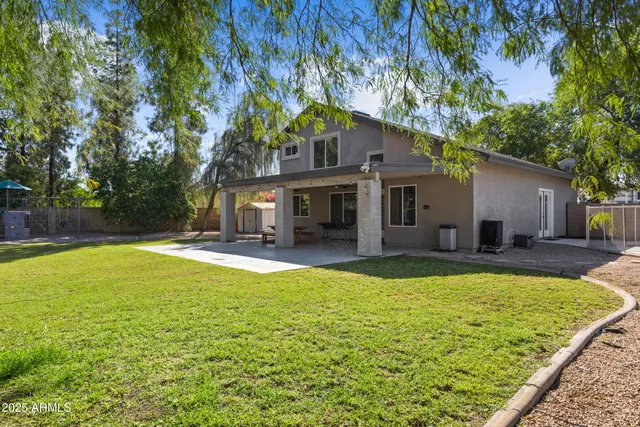 a view of a house with swimming pool and a yard