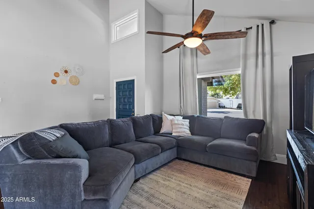 a living room with furniture and a wooden floor