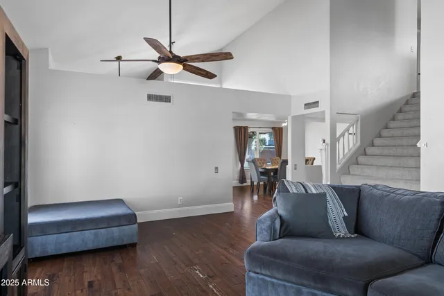 a living room with a balcony a bed furniture and a window