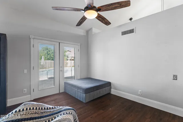 a view of a hallway with wooden floor and a living room