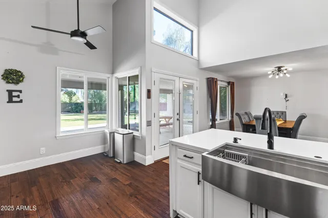 a kitchen with cabinets stainless steel appliances and a wooden floor