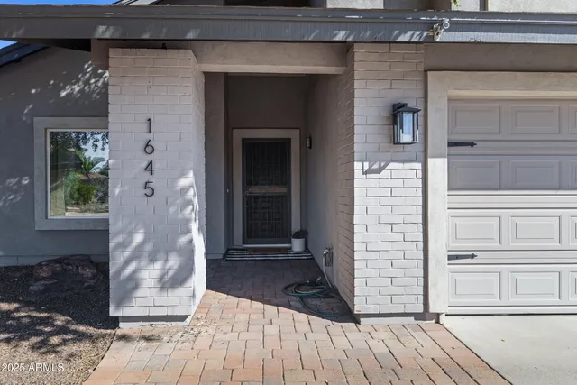 a view of front door of house with stairs
