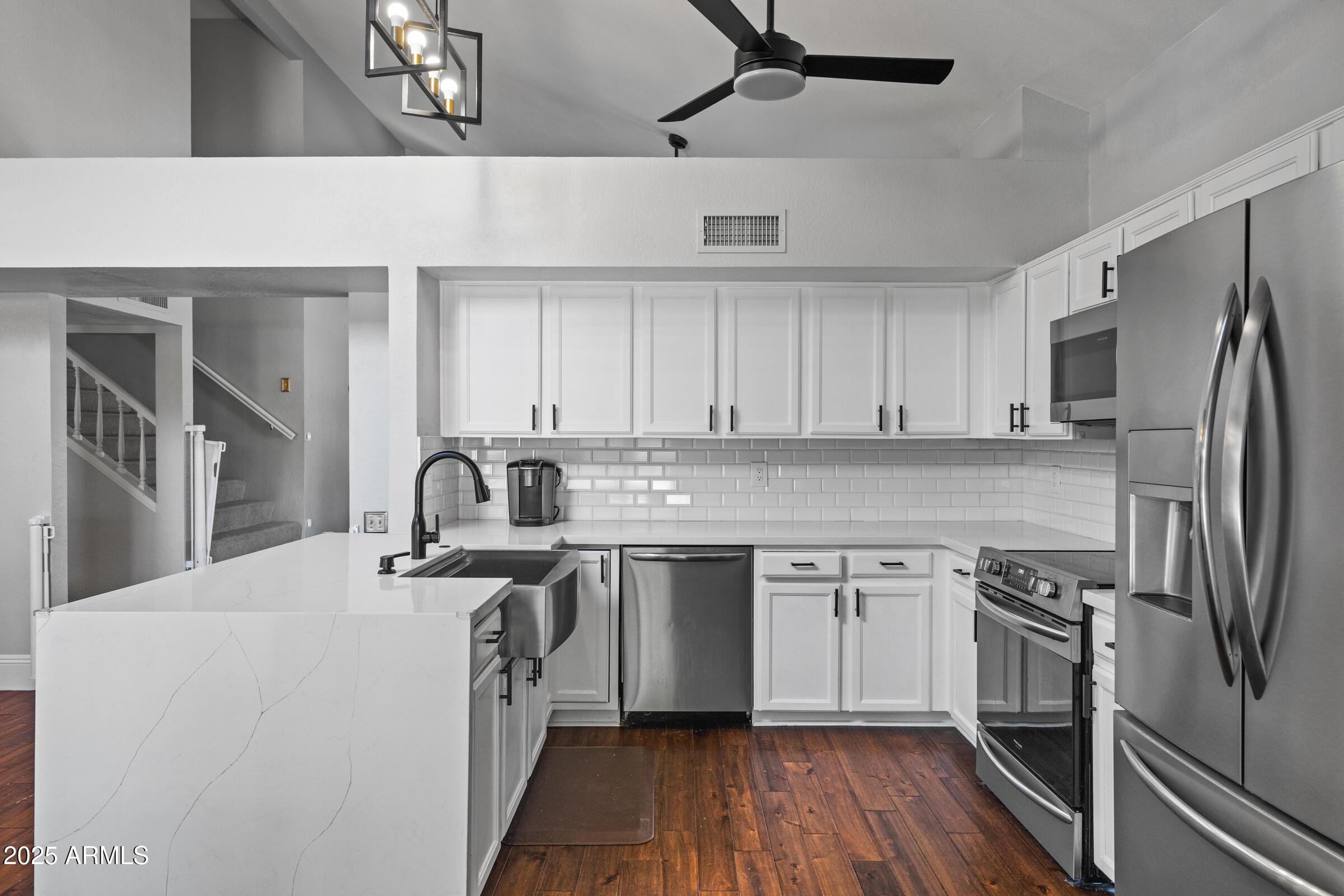 1645 North Saguaro Street Chandler, AZ 85224 - Photo 22 of 45 a kitchen with stainless steel appliances granite countertop a sink stove a refrigerator and cabinets