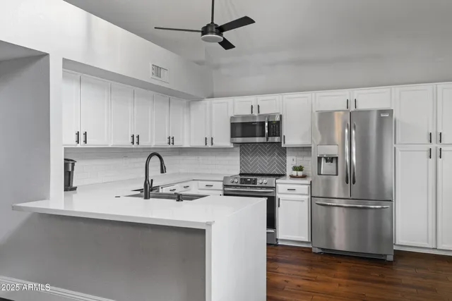 a kitchen with stainless steel appliances a sink stove and refrigerator
