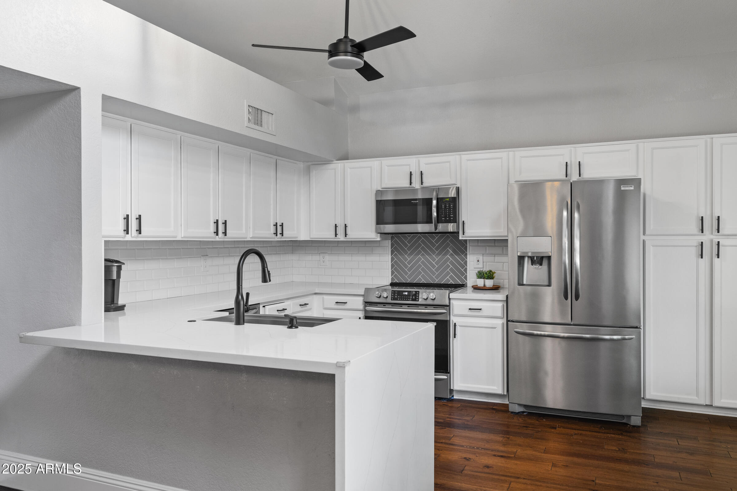 1645 North Saguaro Street Chandler, AZ 85224 - Photo 23 of 45 a kitchen with stainless steel appliances a refrigerator sink and microwave
