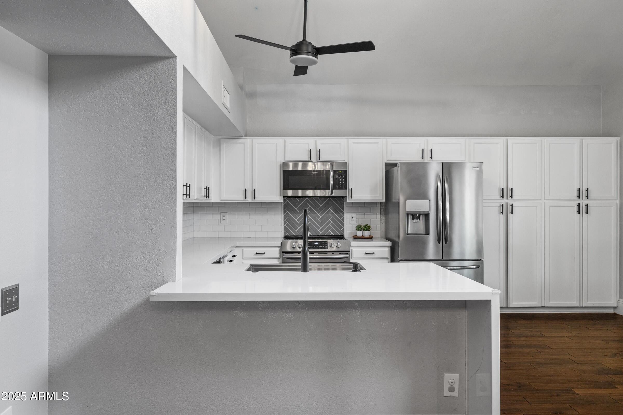 1645 North Saguaro Street Chandler, AZ 85224 - Photo 24 of 45 a kitchen with stainless steel appliances a sink stove and refrigerator
