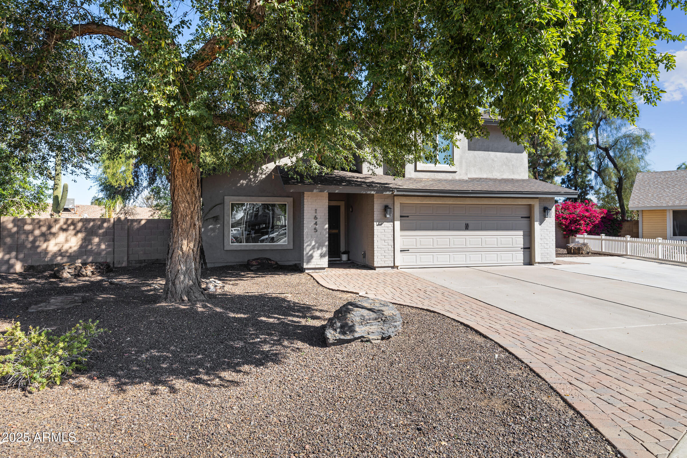 1645 North Saguaro Street Chandler, AZ 85224 - Photo 3 of 45 a front view of a house with a yard and garage