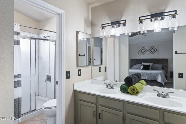 a bathroom with double vanity sink and a mirror
