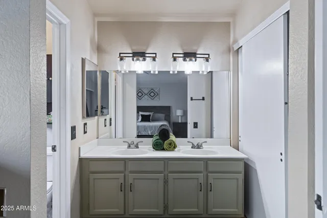 a bedroom with a bed and a mirror